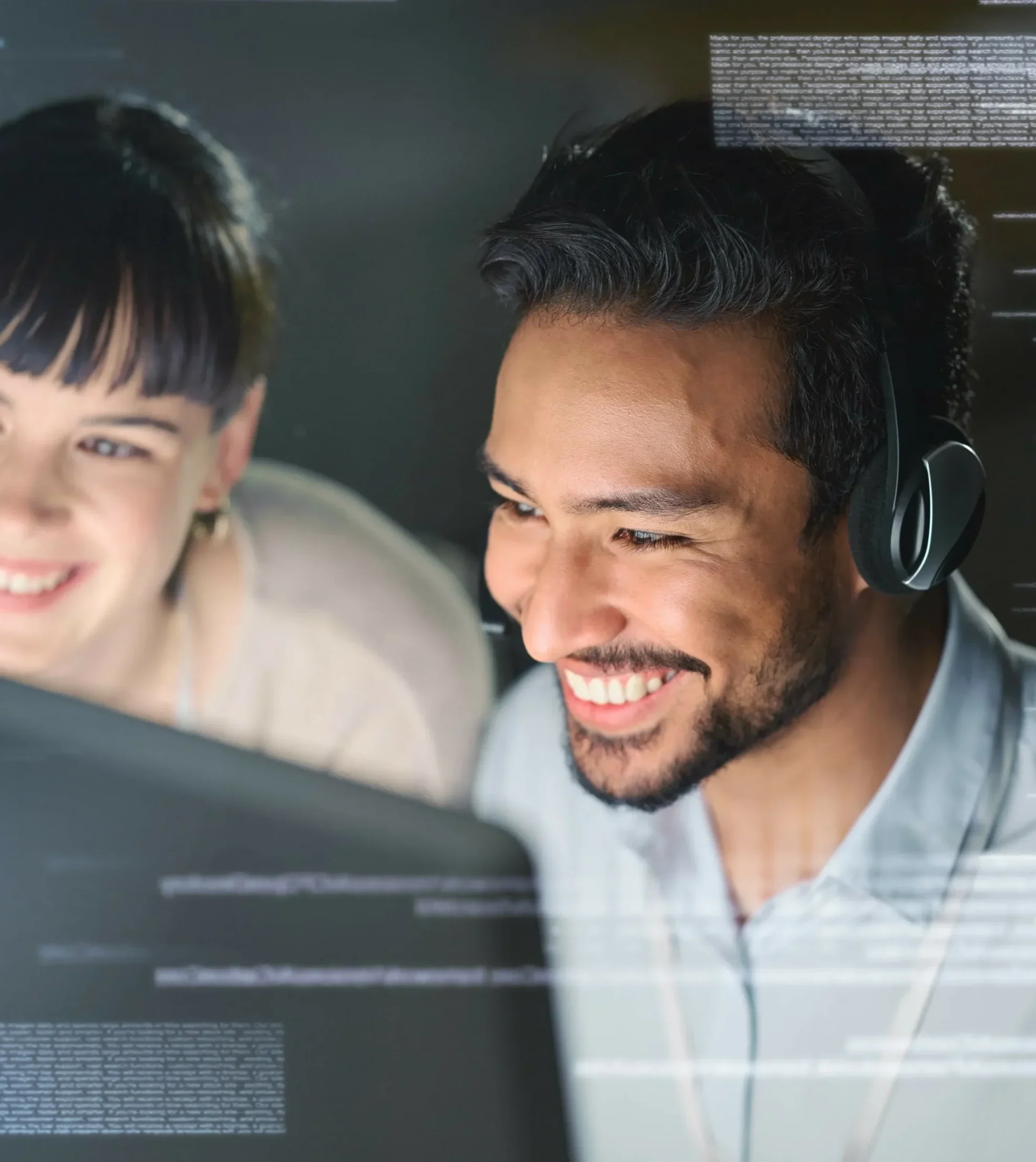 Smiling IT support professionals collaborating at a computer, representing ITech Plus's comprehensive IT solutions for businesses in Lakeland, FL.